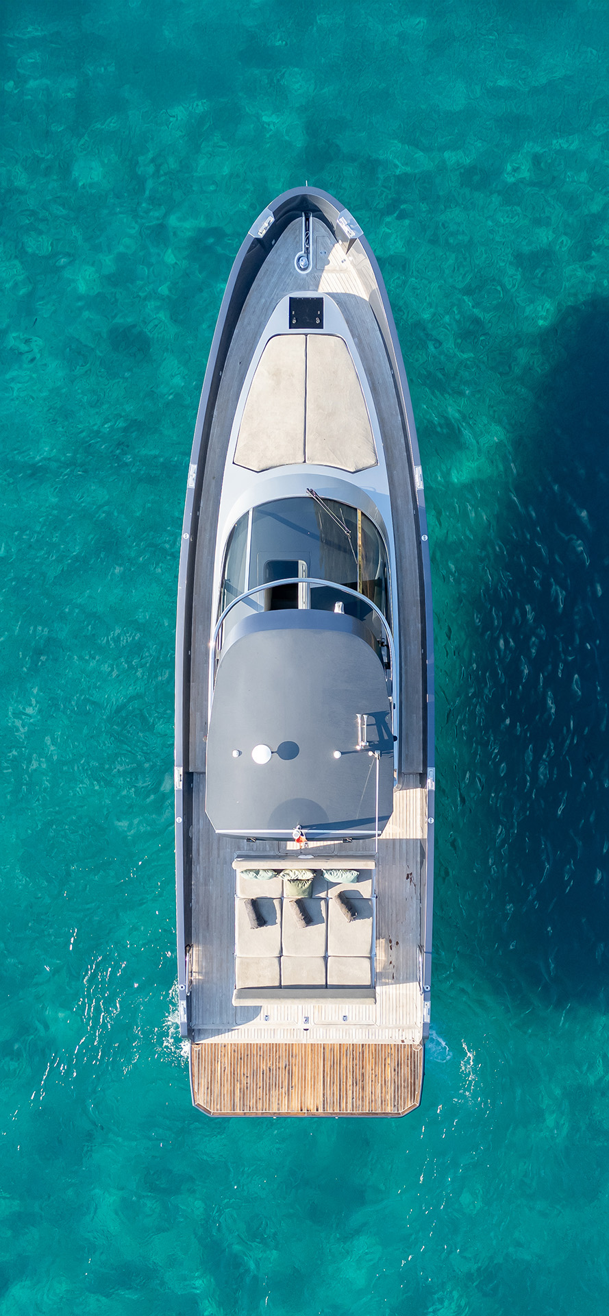 Photo of our yacht ‘Layback’ from above, sailing across the clear blue Mediterranean Sea.
